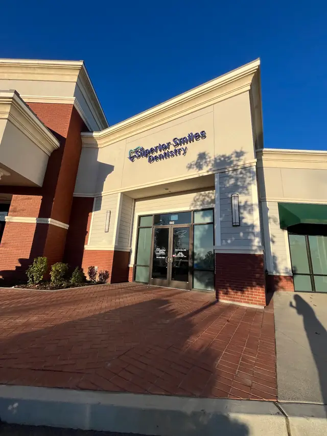 Superior Smiles Dentistry storefront under a clear blue sky